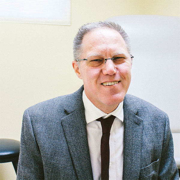 Dr. Dodde in his office smiling for picture